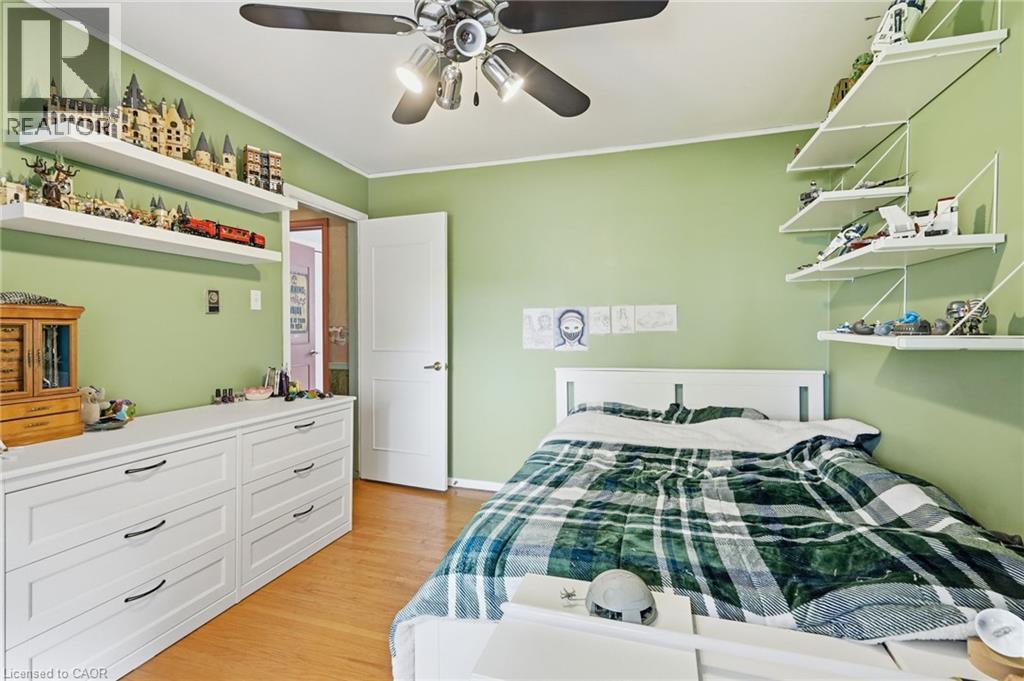 Wood-finish flooring with a ceiling fan light fixture - 1311 W Concession 6 Road, Flamborough, ON