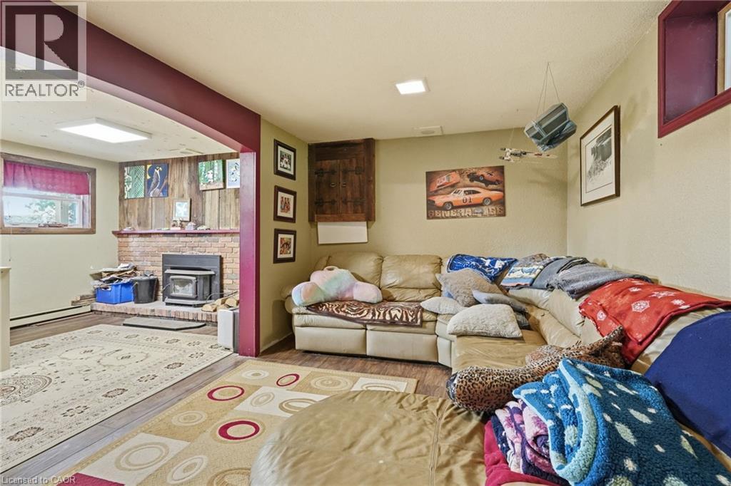 Exposed brick fireplace with a wood-burning insert - 1311 W Concession 6 Road, Flamborough, ON