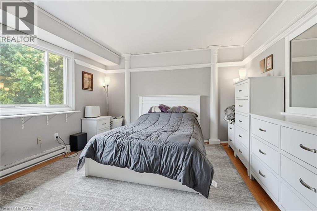 Wood-finish flooring with a light-toned area rug - 1311 W Concession 6 Road, Flamborough, ON