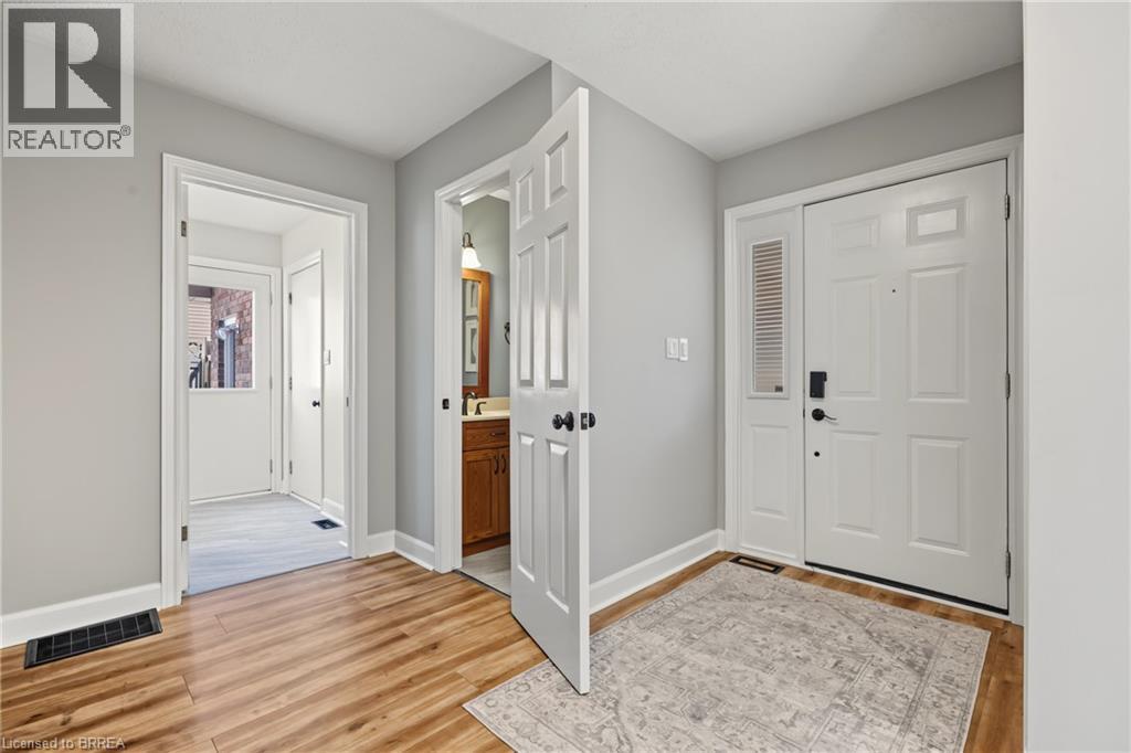 Wood-finish flooring, white paneled doors, and light gray wall paint - 141 Race Street, Paris, ON