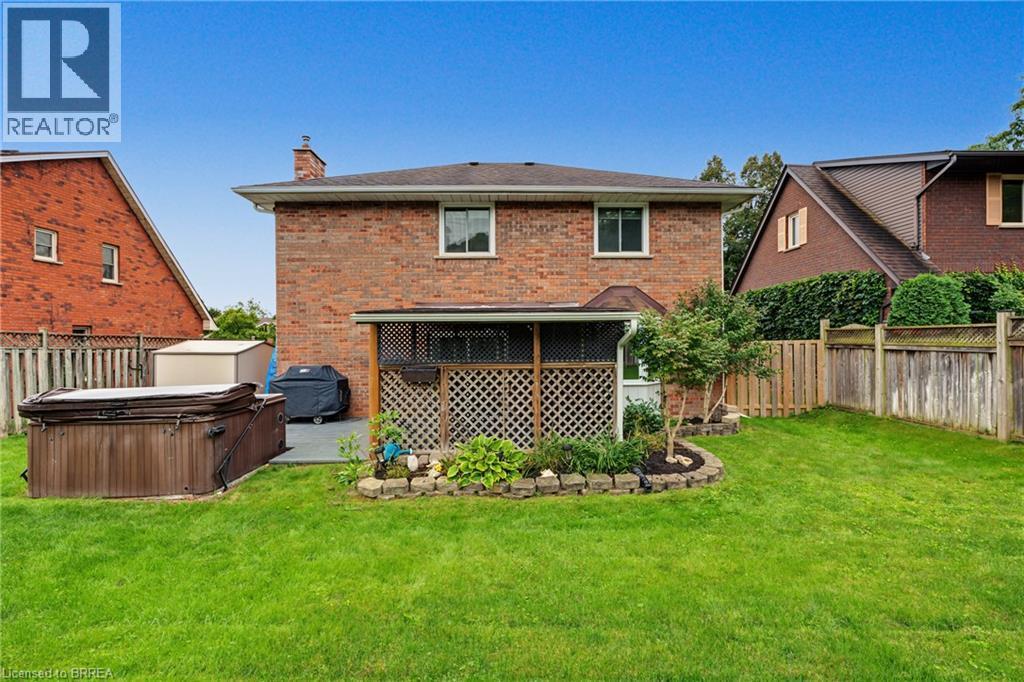 Brick exterior with a covered patio area and an integrated garden bed - 141 Race Street, Paris, ON