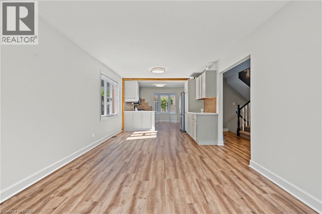 Wood-finish flooring throughout, white walls, and a recessed window - 141 Race Street, Paris, ON