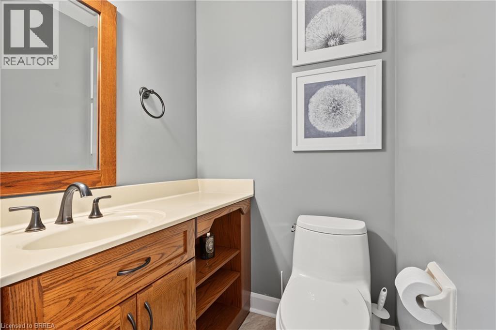 Vanity with wood-finish cabinetry, integrated sink, and bronze-finish faucet - 141 Race Street, Paris, ON