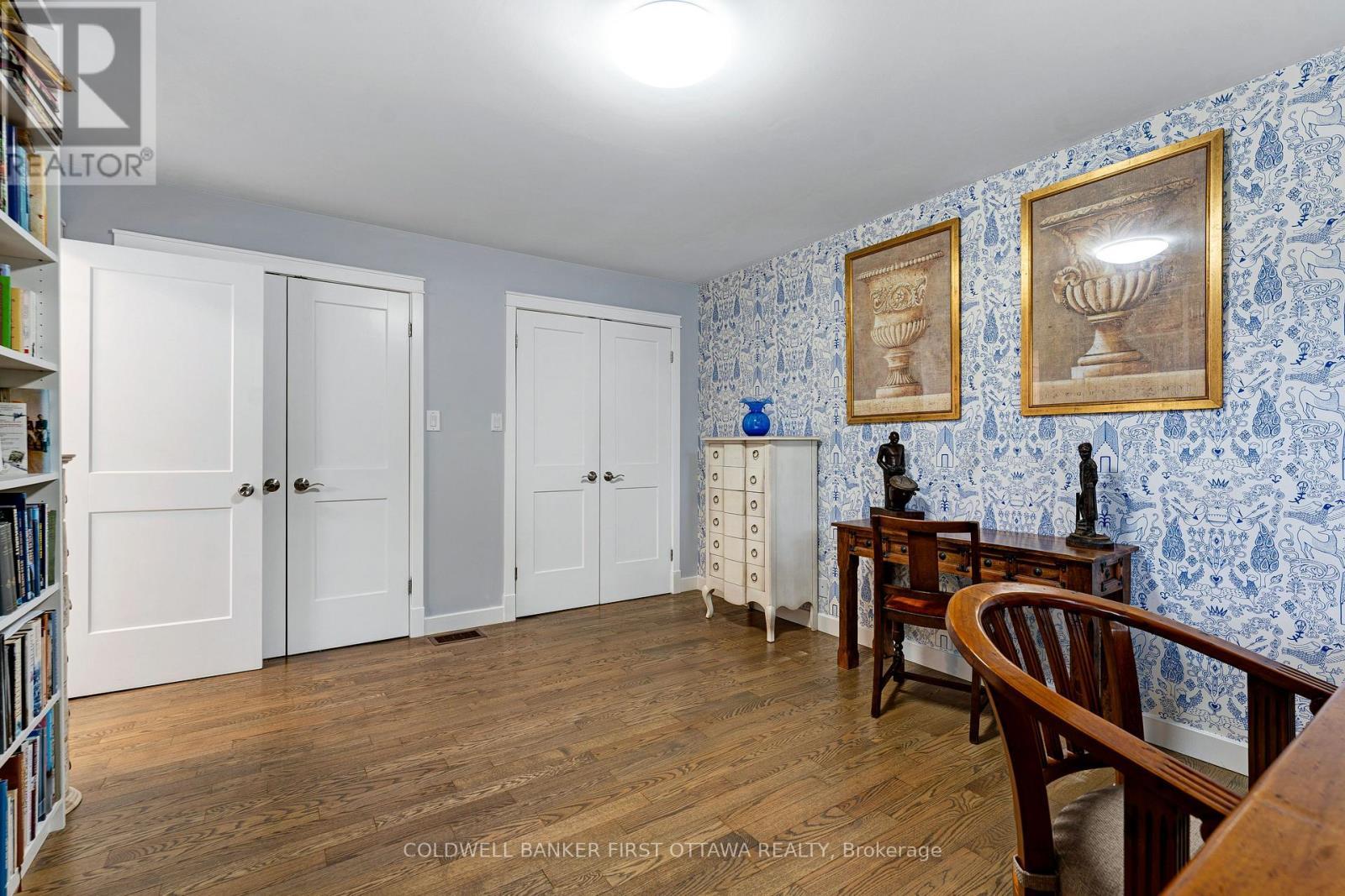 Main floor bedroom with hardwood floor and closets - 25 Robert Road, Perth, ON