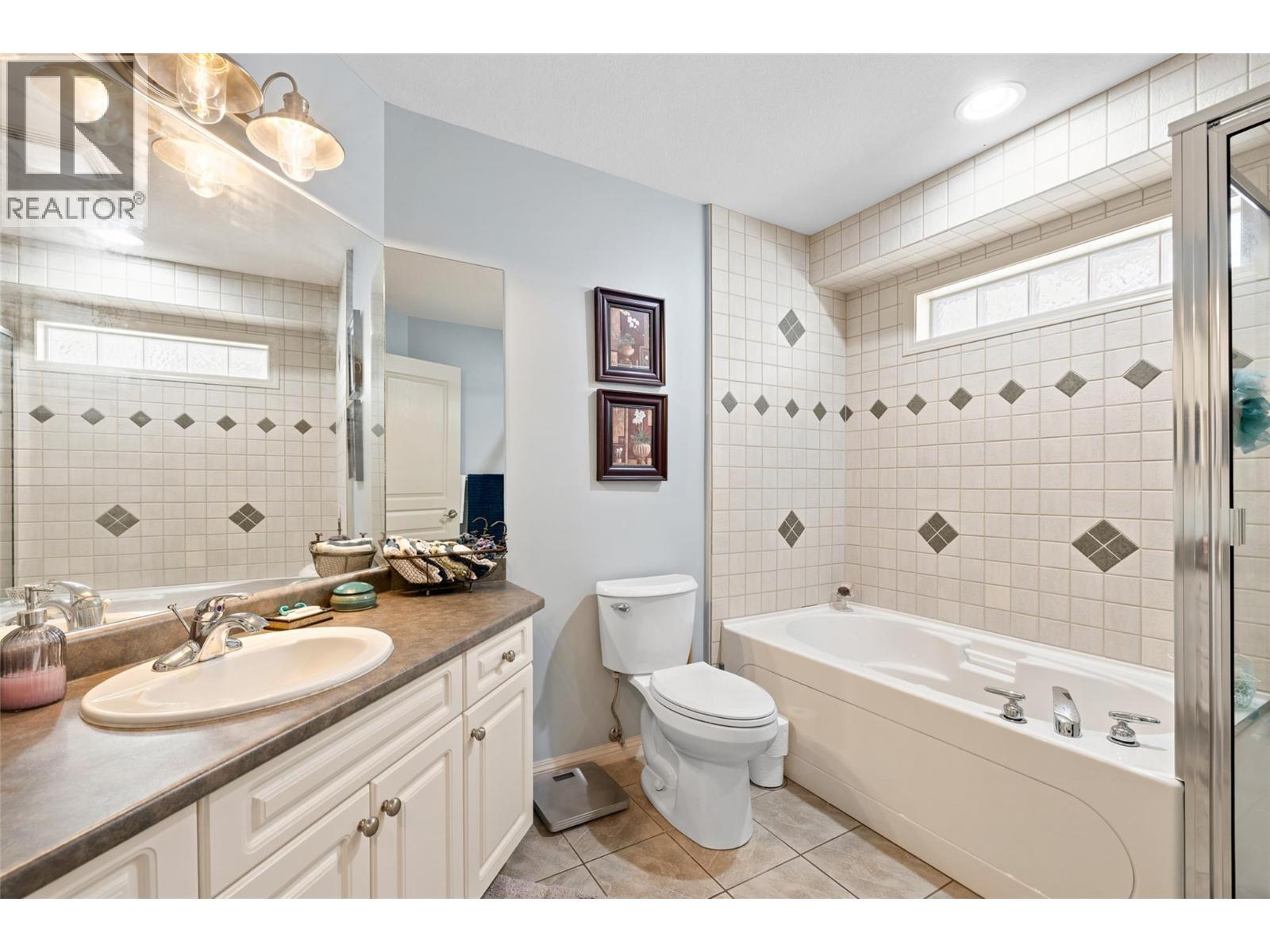 Three full bathrooms provide convenience for family and guests. - 1188 Houghton Road Unit# 122, Kelowna, BC