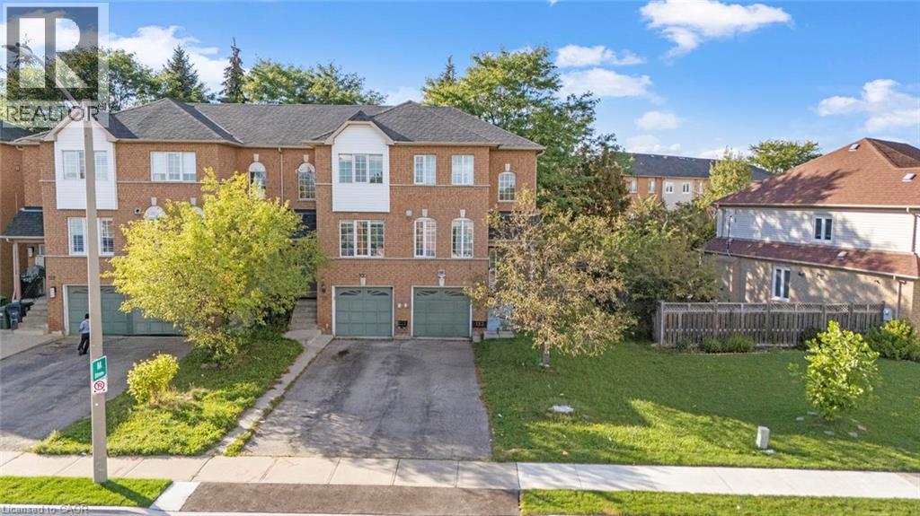 Brick exterior with white window frames and multiple arched windows - 123 Brickyard Way, Brampton, ON