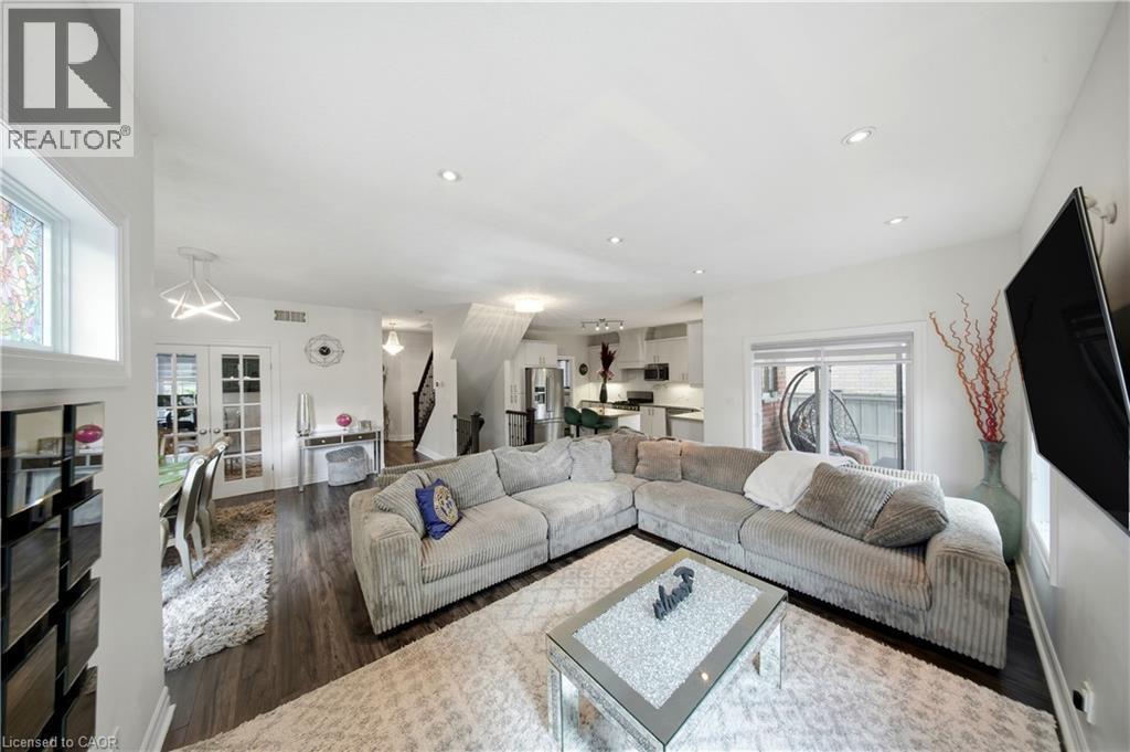 Recessed lighting, wood-finish flooring, and white walls create a bright interior - 167 Broadoaks Drive, Cambridge, ON