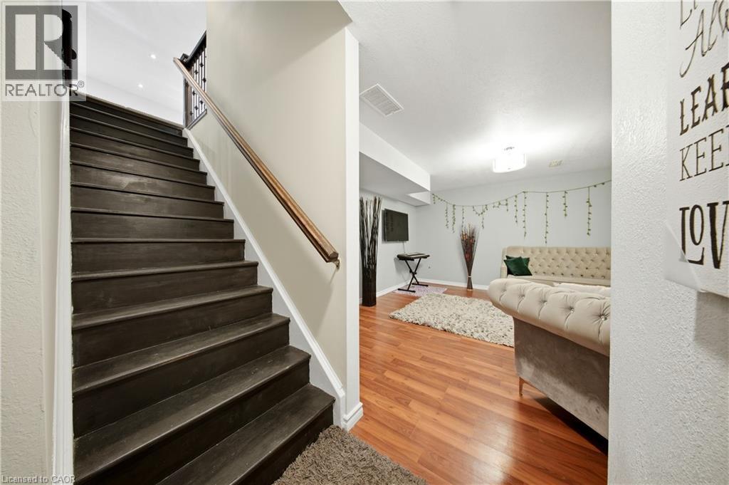 Wood-finish flooring, recessed lighting, and a neutral color palette - 167 Broadoaks Drive, Cambridge, ON