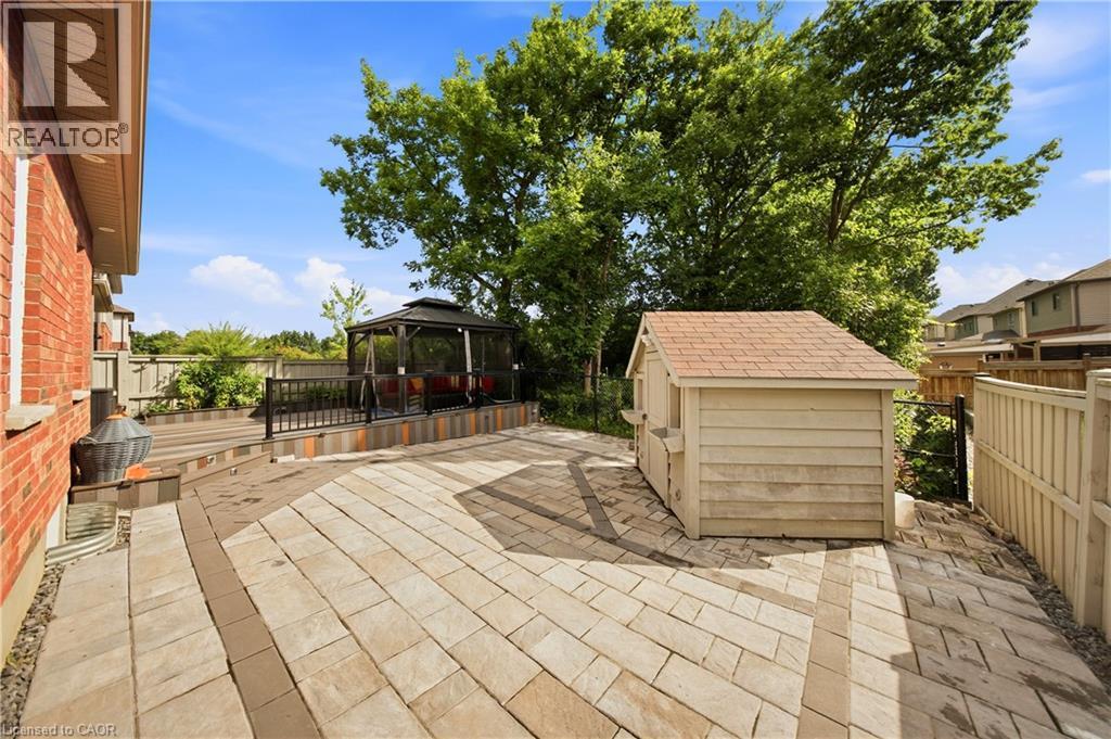 Expansive paver patio with a multi-level design - 167 Broadoaks Drive, Cambridge, ON