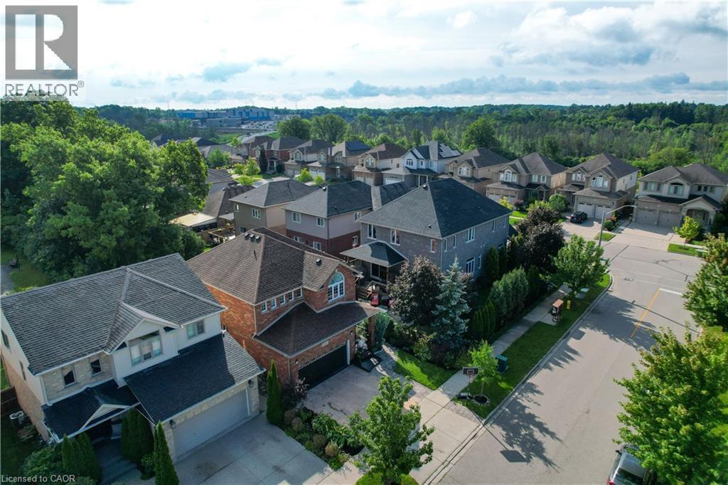 Residential neighborhood with mature trees, paved streets, and a mix of brick and siding exteriors - 167 Broadoaks Drive, Cambridge, ON