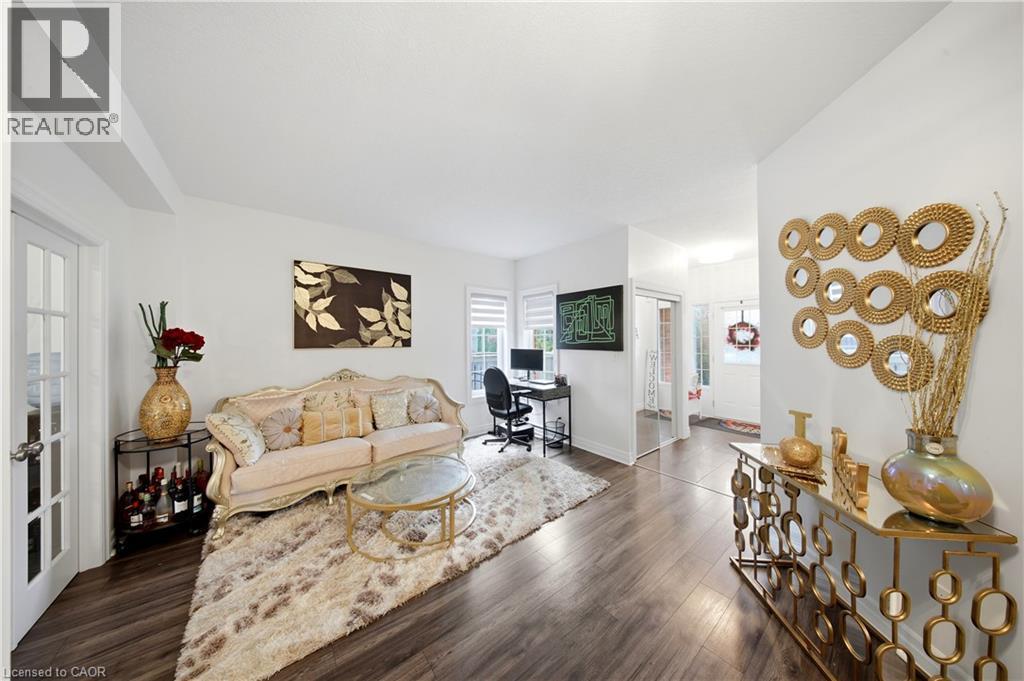 Wood-finish flooring throughout, white painted walls, and a white ceiling create a bright interior - 167 Broadoaks Drive, Cambridge, ON