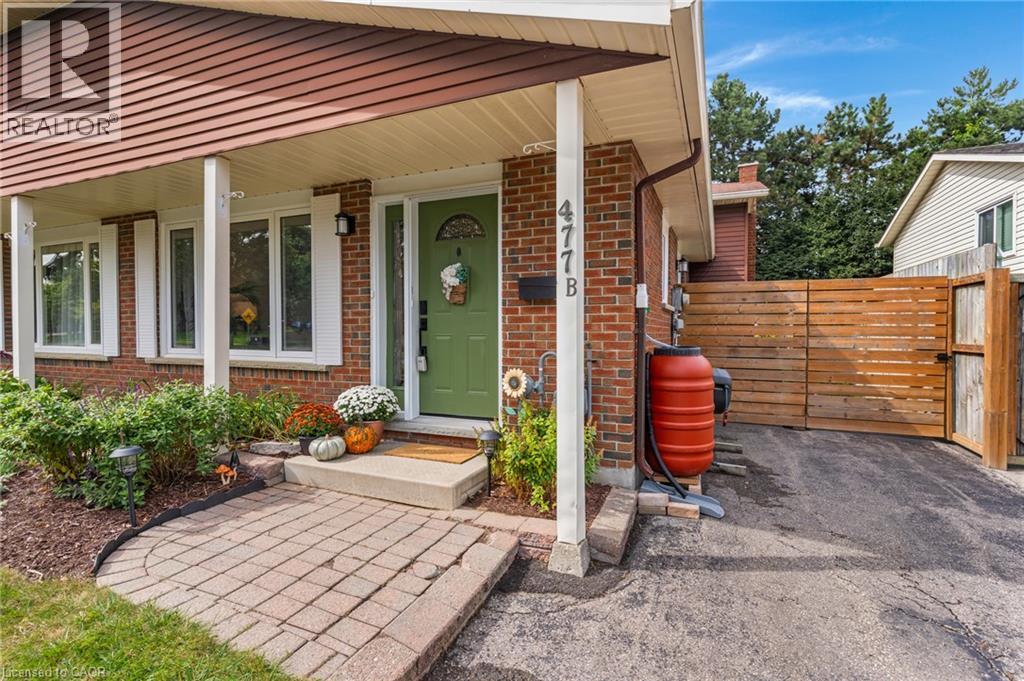 Brick exterior featuring a covered entry with white columns - 477 Kingscourt Drive Unit# B, Waterloo, ON