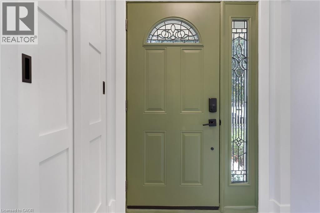 Entry door with an arched decorative glass transom and a full-length decorative glass sidelight - 477 Kingscourt Drive Unit# B, Waterloo, ON