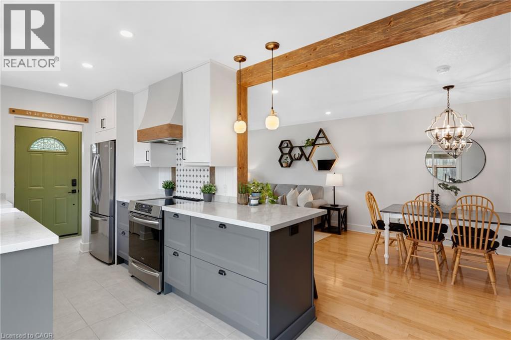 Contemporary kitchen featuring gray base cabinetry, stainless steel appliances, and light-toned countertops - 477 Kingscourt Drive Unit# B, Waterloo, ON