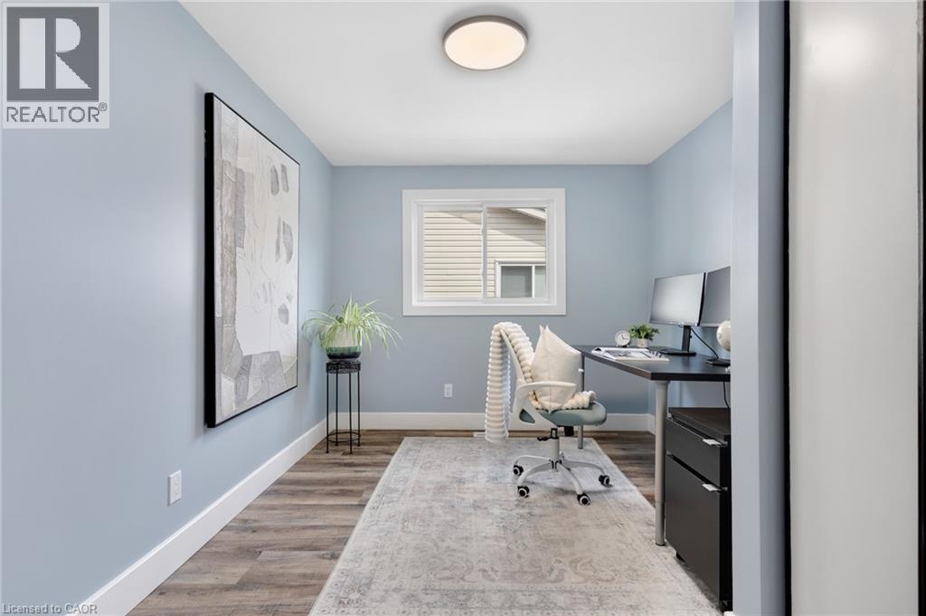 Wood-finish flooring, white trim, and a window with a white frame - 477 Kingscourt Drive Unit# B, Waterloo, ON