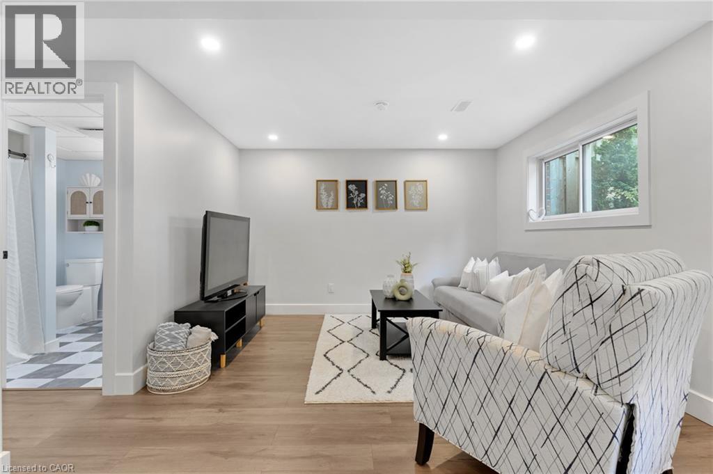 Recessed lighting, wood-finish flooring, and a window with white trim - 477 Kingscourt Drive Unit# B, Waterloo, ON
