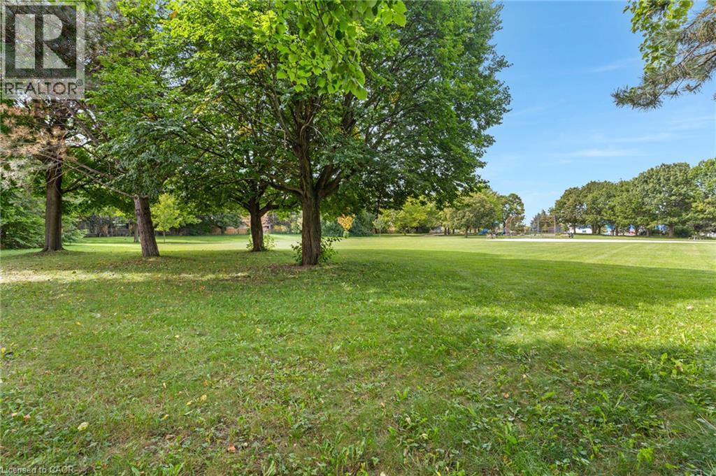 Expansive green lawn with mature trees and substantial open space - 477 Kingscourt Drive Unit# B, Waterloo, ON
