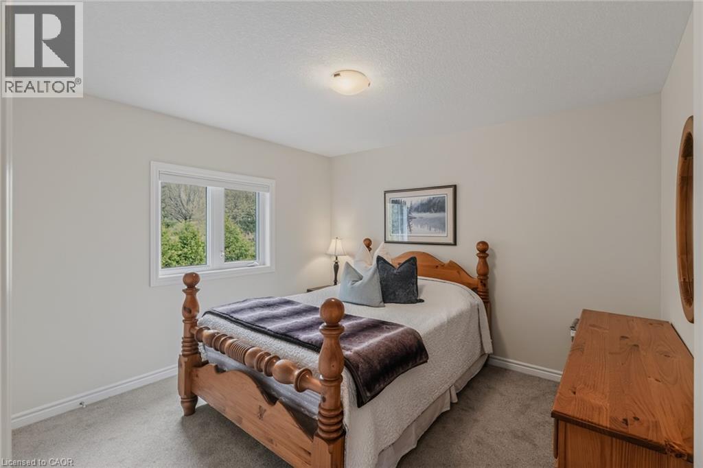 Bedroom featuring a single window, neutral wall paint, white trim, and light grey carpeting - 249 Woodway Trail, Simcoe, ON
