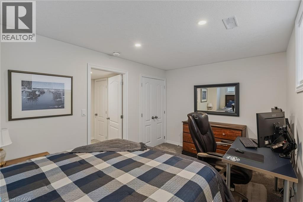 Carpeted room featuring light gray walls and recessed ceiling lighting - 249 Woodway Trail, Simcoe, ON