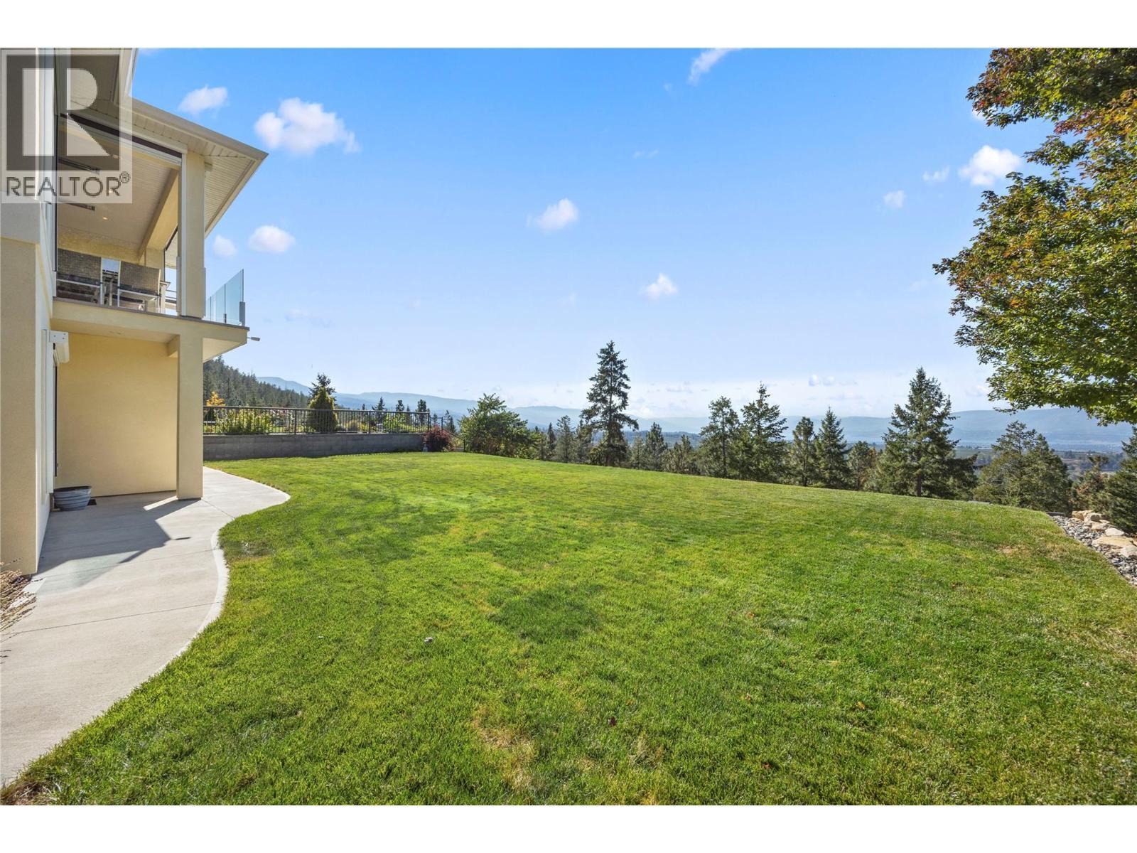 West-facing backyard with expansive lake, valley and mountain views & a large grassy area - 2442 Bella Vista Street, Kelowna, BC