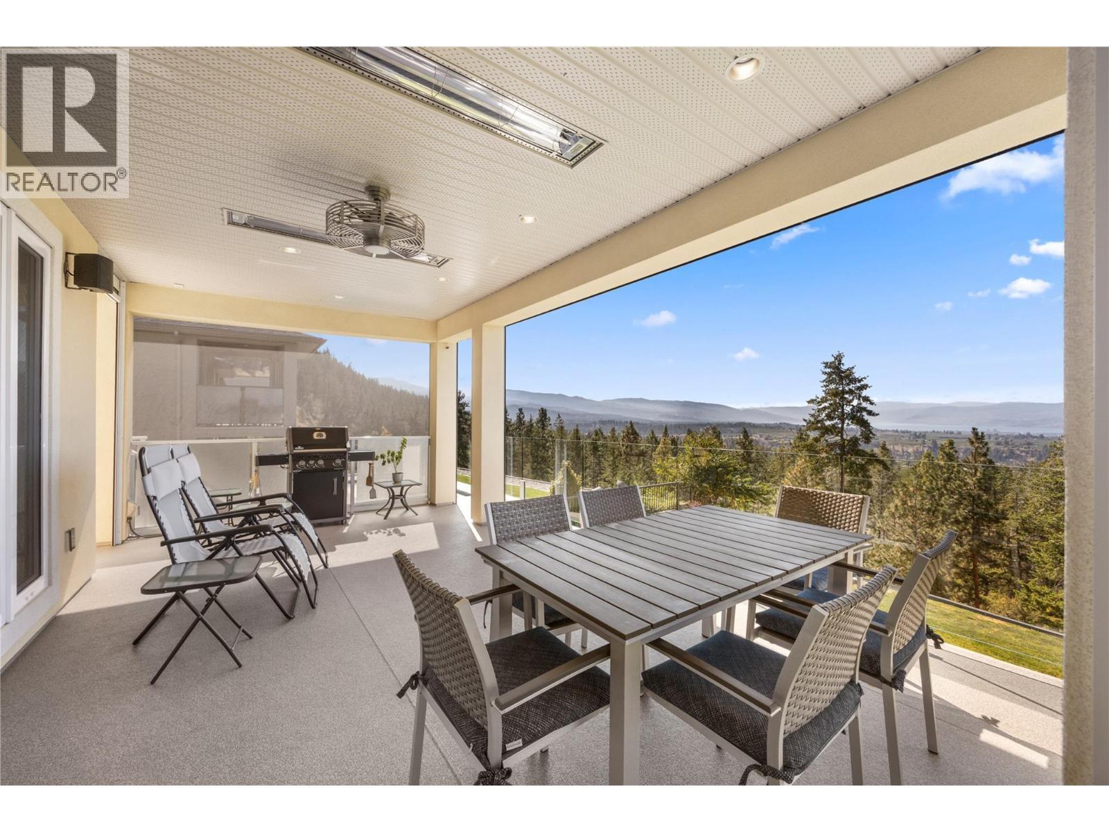 Year-round entertaining space with retractable motorized screens, glass railings, natural gas hookup - 2442 Bella Vista Street, Kelowna, BC
