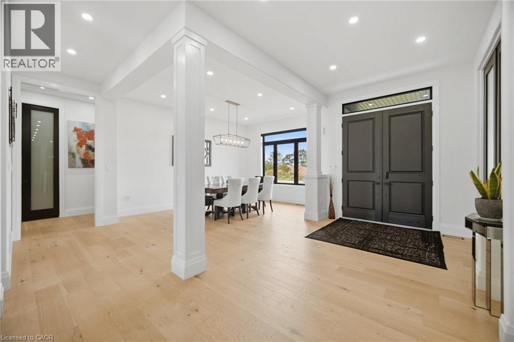 Light wood-finish flooring throughout, recessed lighting, and a double-door entry - 56 Augustus Street, Scotland, ON