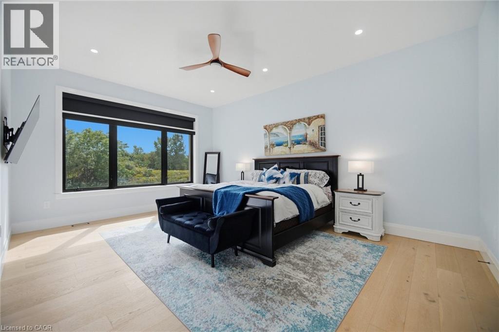 Expansive window with black trim, recessed ceiling lighting, a ceiling fan, and light wood-finish flooring - 56 Augustus Street, Scotland, ON