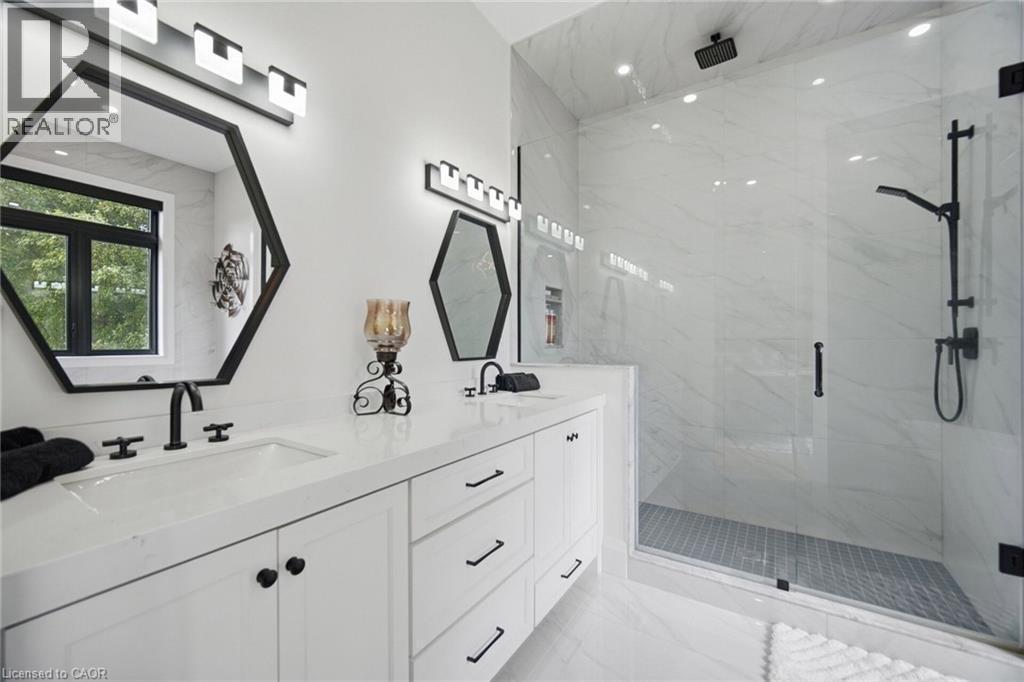 Dual vanity with white cabinetry, hexagonal mirrors, and black fixtures - 56 Augustus Street, Scotland, ON