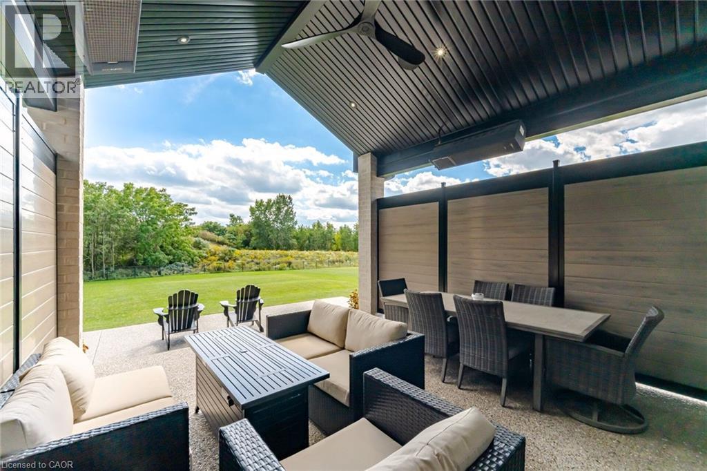 Covered patio with a textured ceiling, recessed lighting, and wall-mounted heaters - 56 Augustus Street, Scotland, ON
