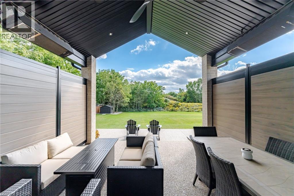 Covered patio with integrated overhead heating, recessed lighting, and a slatted ceiling - 56 Augustus Street, Scotland, ON