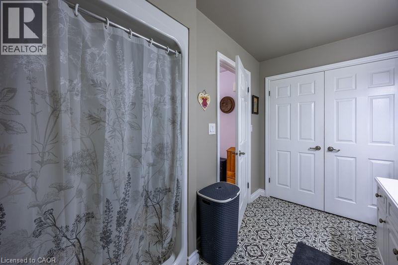 Patterned floor tile, white paneled doors, and neutral wall paint - 123 Mill Street, Delhi, ON