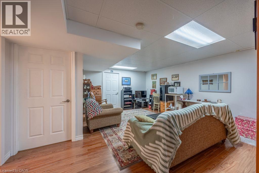 Wood-finish flooring throughout, white paneled doors, and recessed lighting - 123 Mill Street, Delhi, ON