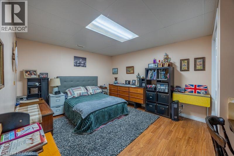Wood-finish flooring, neutral wall tones, and overhead fluorescent lighting - 123 Mill Street, Delhi, ON
