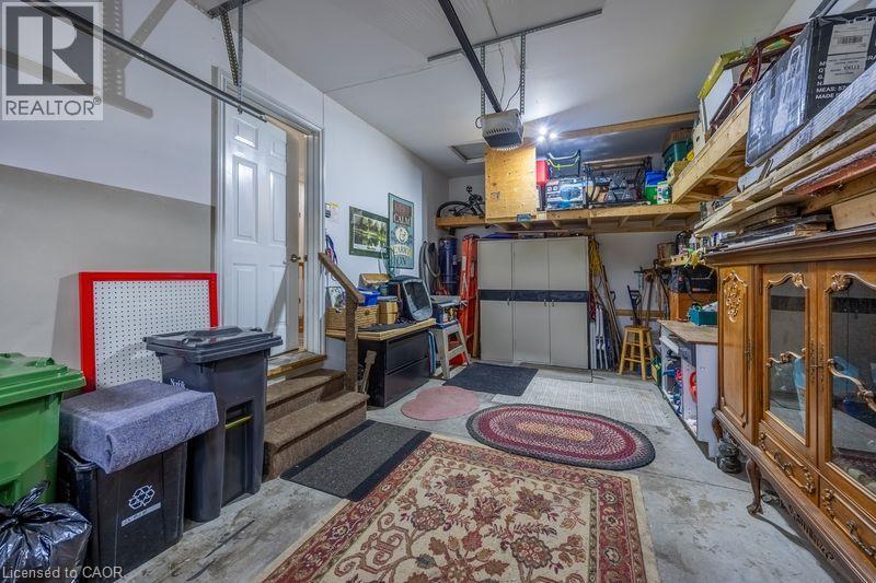 Concrete flooring with built-in overhead storage shelves and a utility door - 123 Mill Street, Delhi, ON