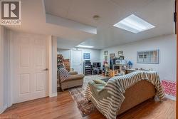 Wood-finish flooring throughout, white paneled doors, and recessed lighting -