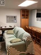 Built-in wooden cabinetry, recessed panel wall mirror, and wood-finish flooring -