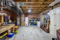 Unfinished lower level featuring exposed ceiling joists, concrete flooring, and an exposed ventilation system -