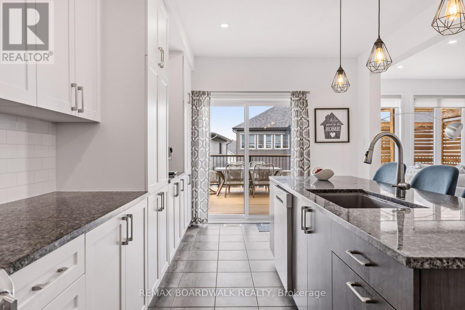Direct kitchen access to the elevated deck - 210 Pingwi Place, Ottawa, ON