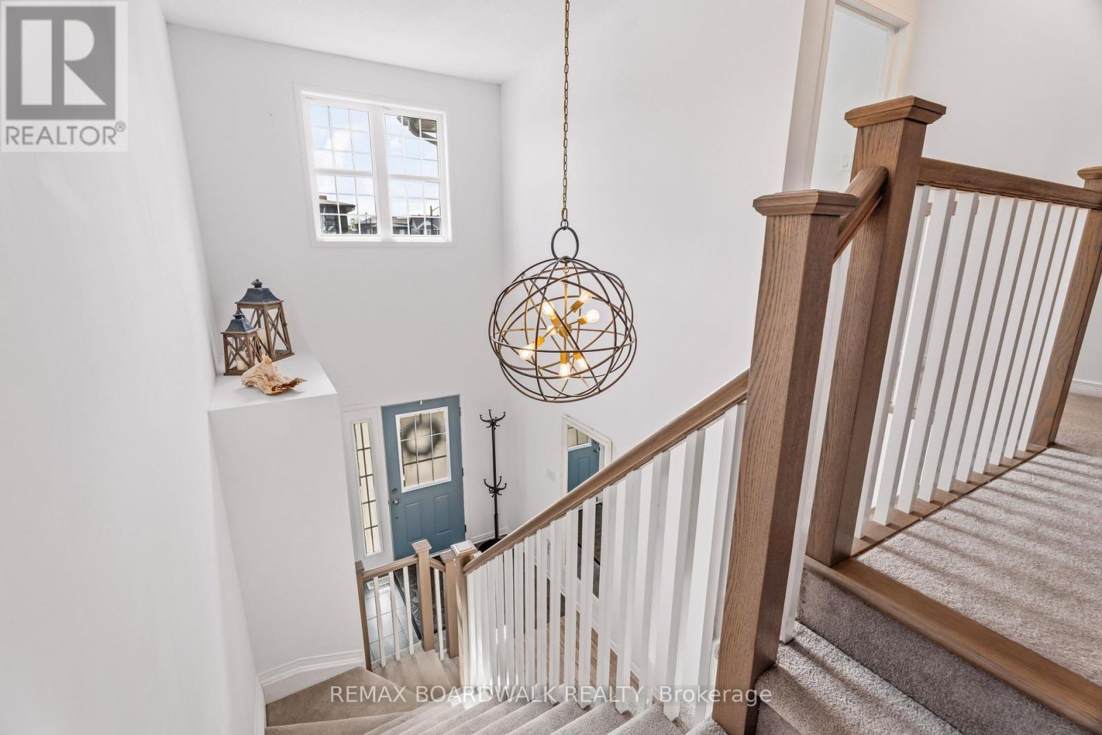 Open staircase filled with natural light - 210 Pingwi Place, Ottawa, ON