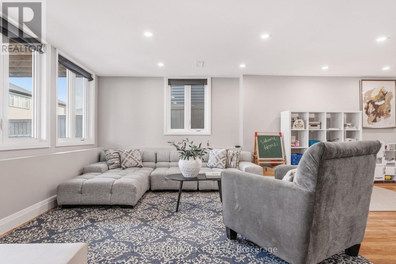 Bright walkout rec room with oversized windows - 210 Pingwi Place, Ottawa, ON