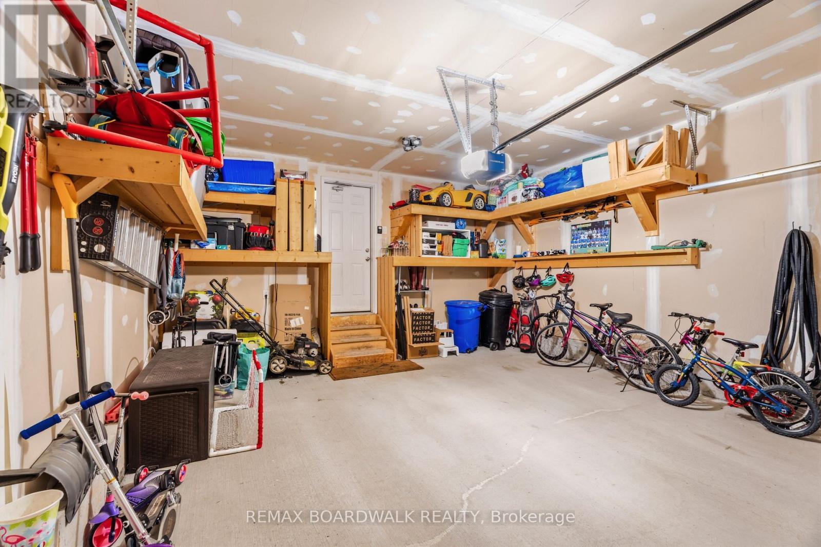 Double garage with custom built-in shelving - 210 Pingwi Place, Ottawa, ON