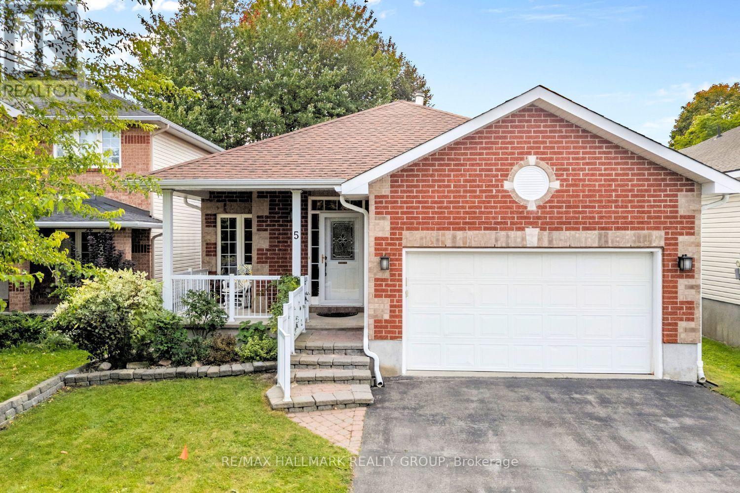 Front exterior with double garage and driveway - 5 Rayburn Street, Ottawa, ON