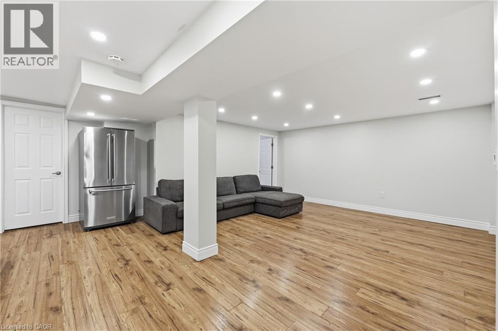 Recessed lighting, wood-finish flooring, white trim, and a stainless steel refrigerator - 312 Upper Paradise Road, Hamilton, ON