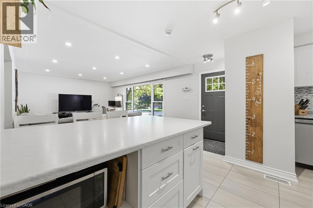 Expansive kitchen island with white cabinetry and a light-toned countertop - 312 Upper Paradise Road, Hamilton, ON