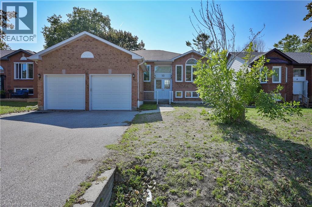 Brick exterior with a prominent two-car garage - 12 Langevin Drive, Wasaga Beach, ON
