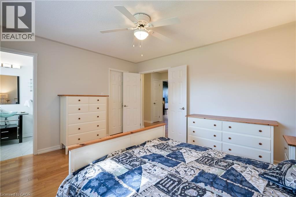 Wood-finish flooring, ceiling fan with integrated lighting, and white paneled doors - 12 Langevin Drive, Wasaga Beach, ON