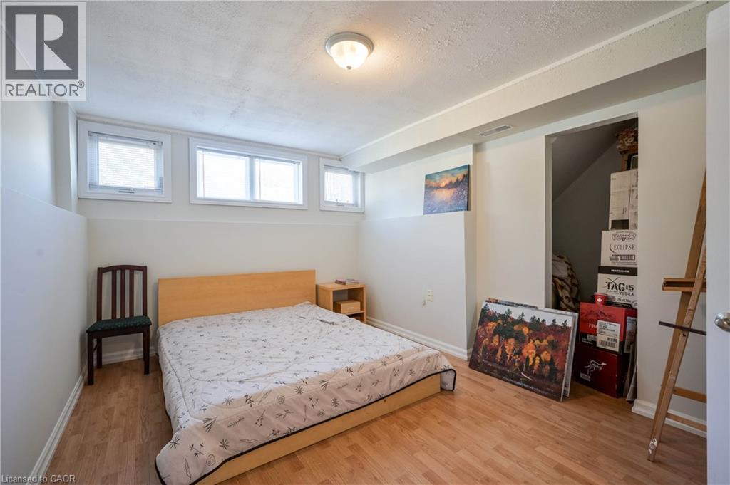 Recessed lighting, wood-finish flooring, and white walls create a neutral palette - 12 Langevin Drive, Wasaga Beach, ON