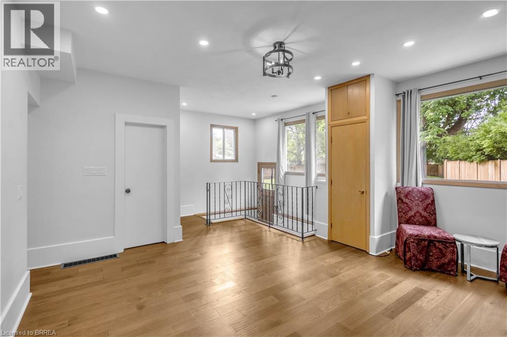 Hardwood-finish flooring, recessed ceiling lighting, built-in storage cabinetry, wrought iron railing, and multiple windows - 11 Tutela Heights Road, Brantford, ON
