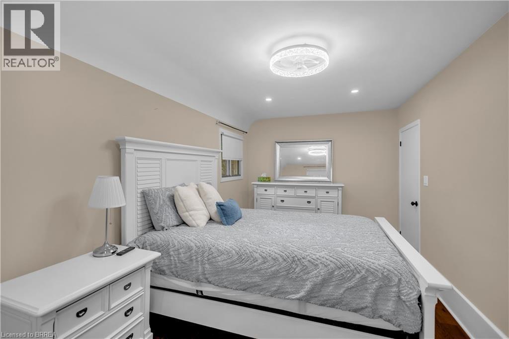 Recessed lighting, ceiling-mounted light fixture, neutral wall color, wood-finish flooring, white door with black hardware - 11 Tutela Heights Road, Brantford, ON