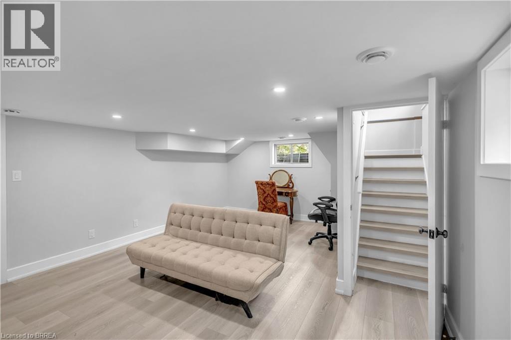 Recessed ceiling lighting, light wood-finish flooring, white trim, white walls, and a visible window - 11 Tutela Heights Road, Brantford, ON
